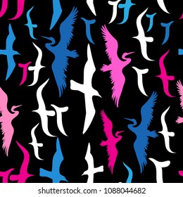 Seamless pattern with silhouettes of flying birds on dark background