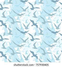 Seamless pattern with silhouettes of flying birds against the backdrop of stormy sky. Vector image in pastel blue color.