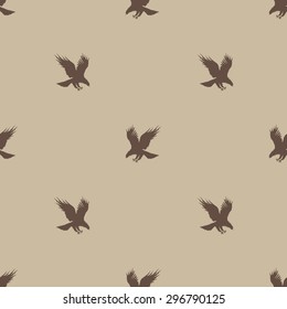 Seamless pattern with silhouettes of flying eagle in brown
