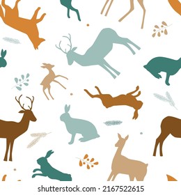 Seamless pattern with silhouettes of wild forest animals, leaves. Natural ornament with hares, foxes, deer. Vector graphics.