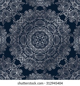 Seamless pattern with silver mandala on a blue background. Vector illustration