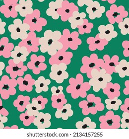 Seamless pattern with simple flowers on a green field. Cute floral print with casual flower heads in retro style. Romantic botanical background. Vector illustration.