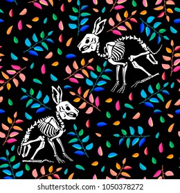 Seamless pattern. Skeleton of a rabbit among multicolored leaves on a black background. Anatomy of a hare. Skull and Bones. Ideal for decoration of Halloween and the Day of the Dead.