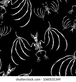 Seamless pattern. A skeletons of a vampire bats on a black background. Great for print on a T-shirt. Ideal for decoration of Halloween and the Day of the Dead.