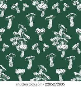 Seamless pattern with sketchy fly agaric mushrooms. Surface graphic design with hand drawn mushrooms on dark green background. Botanical print with amanitas in two colors. Vector illustration.