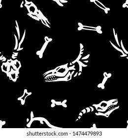 Seamless pattern. Skulls and bones isolated on a black background. Great for greeting cards, invitations, for printing on T-shirts and more. Happy Halloween!