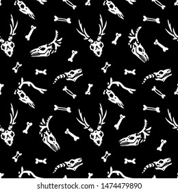 Seamless pattern. Skulls and bones on a black background. Anatomy of magical creatures. Great for greeting cards, invitations, for printing on T-shirts and more. Happy Halloween!