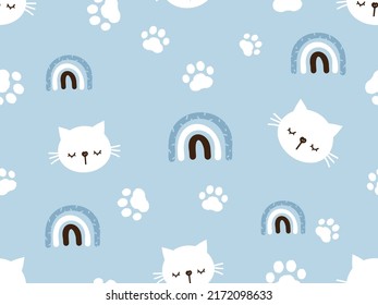 Seamless pattern with sleeping cat cartoons, hand drawn rainbows and paw prints on blue background vector illustration. cute childish print.