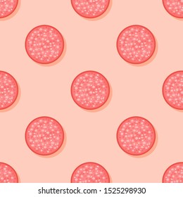 Seamless pattern with slices of salami sausage on orange background. Vector texture.
