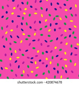 Seamless pattern with small colored sprinkling on a pink background.