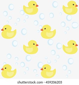 Seamless pattern of small yellow ducks and bubbles on a light background. Vector illustration.