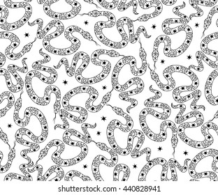 Seamless pattern with snakes. Fashion design in boho style in black and white colors. Hand drawn illustration for fashion, textile, fabric, wrapping paper, material,  tiles, website wallpaper.