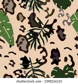 Seamless pattern of snow leopard skins and tropical leaves. Vector image.