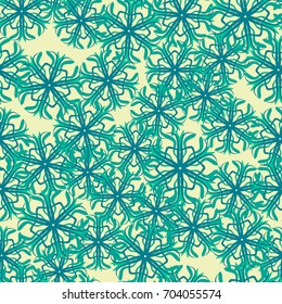 Seamless pattern. Snowflakes are arranged in random order. Yellow, green, blue.
