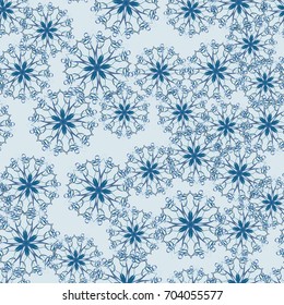 Seamless pattern. Snowflakes are arranged in random order. Blue-gray tones.