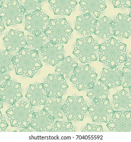 Seamless pattern. Snowflakes are arranged in random order. Yellow, green.