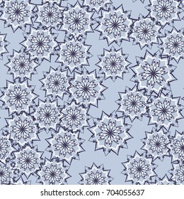 Seamless pattern. Snowflakes are arranged in random order. Gray-blue colors.