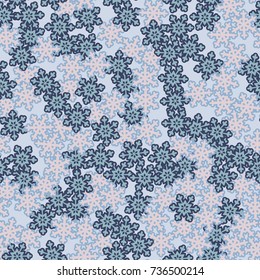 Seamless pattern. Snowflakes in a chaotic vortex. Winter background.