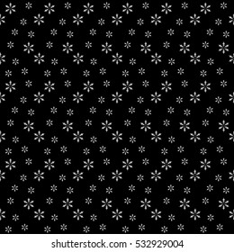 Seamless pattern from snowflakes on black background. An ordered pattern of decorative elements. Winter background for various graphic works.