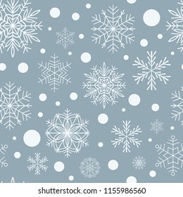 Seamless pattern of snowflakes on a blue background. Winter background for Christmas or New Year design.