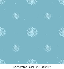 Seamless pattern of snowflakes on a blue background.