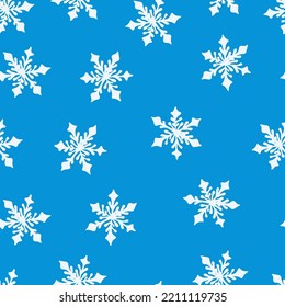 Patrón sin foco con copos de nieve en un patrón navideño de fondo azul. Imagen de invierno