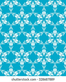 Seamless pattern from snowflakes on a blue background