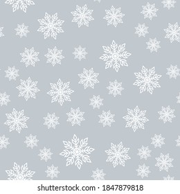 Seamless pattern of snowflakes on a gray background.