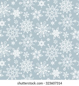 Seamless pattern from snowflakes on a gray background