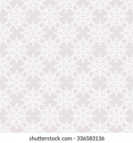 Seamless pattern from snowflakes on a gray background