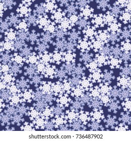 Seamless pattern. Snowflakes are scattered in disorder. New Year's background.