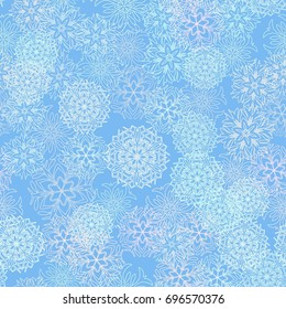 Seamless pattern. Snowflakes in white and blue shades.