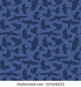 Seamless pattern with soaring birds silhouettes. Dark blue print on blue background