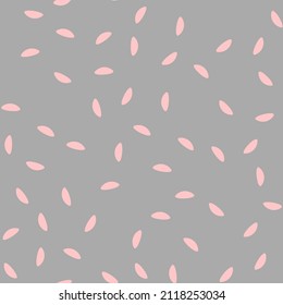 Seamless pattern with spots. Abstract geometric pattern with pink specks on a grey background. Random, chaotic pastel background with cute dots.