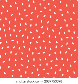 Seamless pattern with sprinkles and red background.