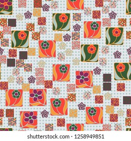 Seamless pattern. Squares containing flowers surrounded by a placer of abstract elements are located against the background of rows of small squares.