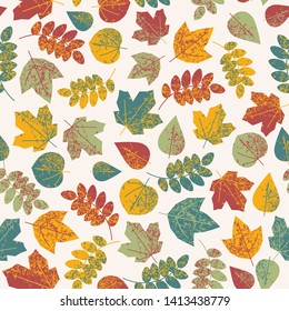seamless pattern strewn with autumnal multi-colored warm gamut of leaves for autumn design of postcard, banner, poster