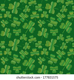 A seamless pattern of striped shamrocks randomly scattered on a green background.