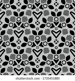 Seamless pattern of stylized leaves, hearts and circles on a gray background.