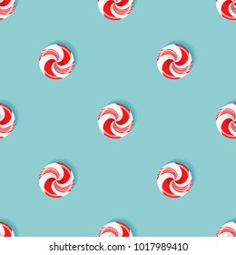 Seamless pattern with sugarplum lollypops. Bright red and white elements isolated on spearmint color background. Vector endless design for wrapping, fabric, backdrops