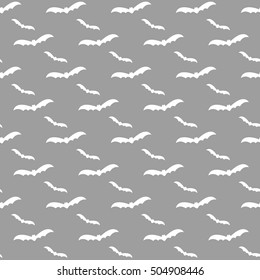 Seamless pattern swarm of bats on the white background.