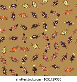 Seamless pattern of sweet candy on beige, black and orange colors. Vector illustration.