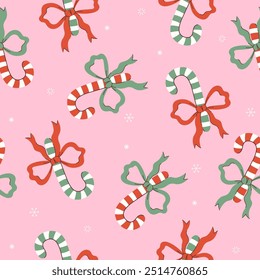 Seamless pattern with sweet canes with bows. Vector graphics.