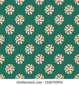 Seamless pattern of sweet Christmas candy lollipop with red, green and white strips on green background. Graphic element for greeting card on New Year and Christmas. Vector illustration