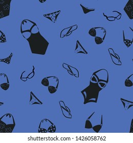 Seamless pattern of swimsuits and bikini on a blue background
