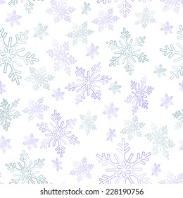 Seamless pattern of swirling in the air blue snowflakes on a white background