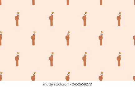 Seamless pattern with Symbol of LGBTQ pride community. LGBT heart hand holding love. Finger heart gesture. LGBT pride month. Rainbow background. Vector illustration
