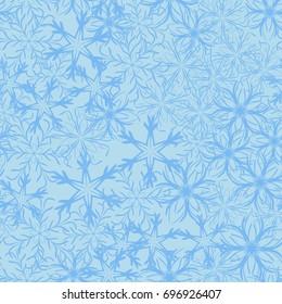 Seamless pattern. Symbolical snowfall. Snowflakes in white and blue tones.