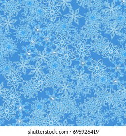 Seamless pattern. Symbolical snowfall. Snowflakes in white and blue tones.