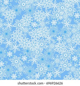 Seamless pattern. Symbolical snowfall. Snowflakes in white and blue tones.
